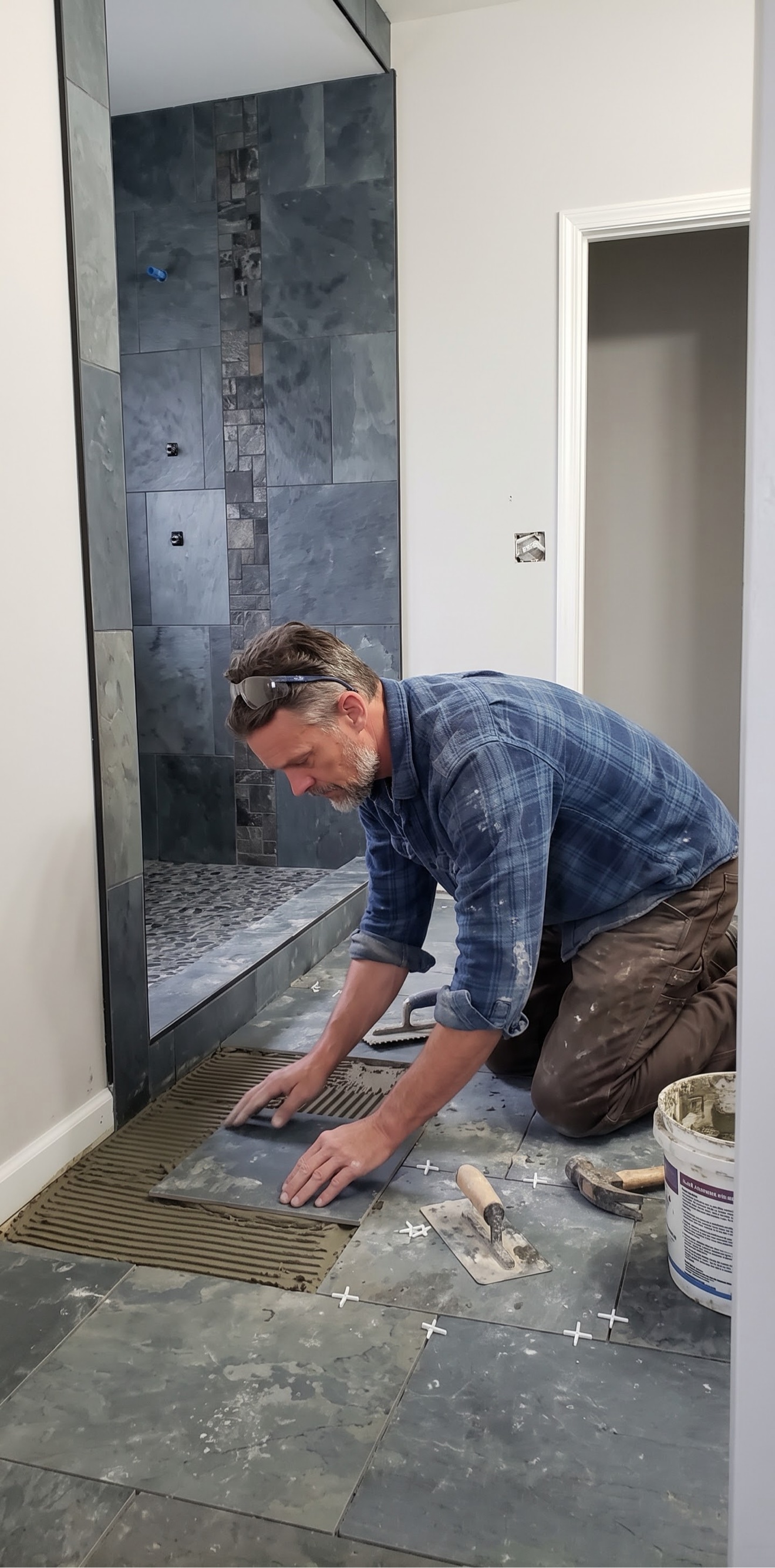 Simon laying a slate bathroom floor in Colorado Springs